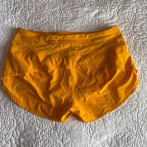 Orange lululemon speed up short reg. Rise 2.5 inch inseams size 2